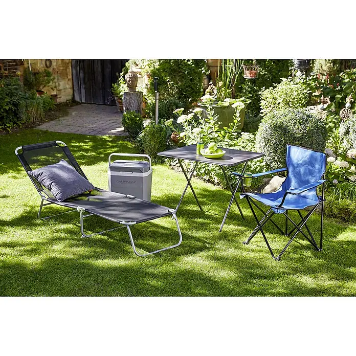 MFG Campingtisch - L x B x H: 80 x 60 x 63 cm, Stahl, Sevelit, Eisengrau, Klappbar - Eine Gartenszene mit einem Campingstuhl, einer Liege, einem Tisch und einer Kühlbox auf einem grünen Rasen.