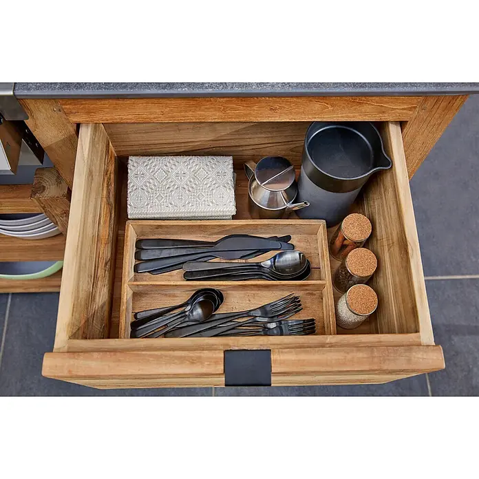Sunfun Zoe Outdoorküchen-Modul Schubladenschrank - Braun, B x T x H: 58 x 63 x 92 cm, Teakholz - Ein offener Schubladenschrank mit einer Auswahl an schwarzem Besteck, Servietten, Gewürzgläsern und Utensilien für die Küche.