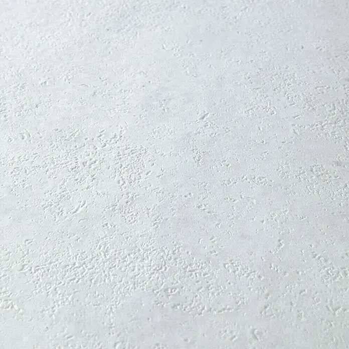 Grosfillex Wall+ Wandpaneel - White Stone, 600 x 300 x 5 mm - Die Nahaufnahme zeigt die Textur einer weißen Wand mit unregelmäßigen, leicht erhabenen Mustern, die für eine interessante Oberfläche sorgen.
