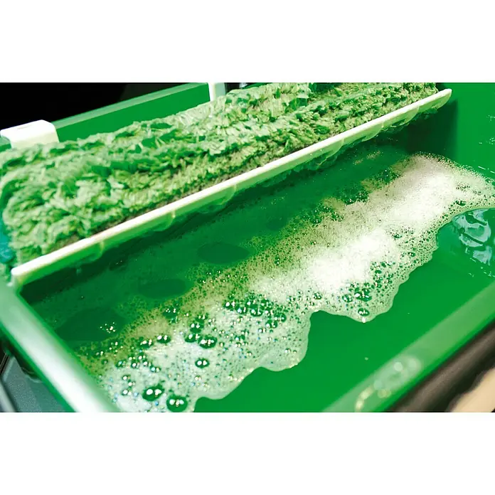 Unger Glasreiniger Liquid - 1 l, Flasche - Ein grüner Fensterwischer liegt in einem grünen Behälter mit Seifenlauge, ideal für streifenfreie Sauberkeit.
