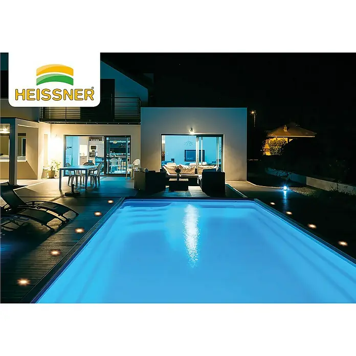 Heissner Bodeneinbauleuchten-Basis-Set Decklights - 3 Stk., Warmweiß - Ein Heissner Pool im Garten bei Nacht, beleuchtet und einladend, mit stilvoller Außenbeleuchtung, die eine entspannende Atmosphäre schafft.