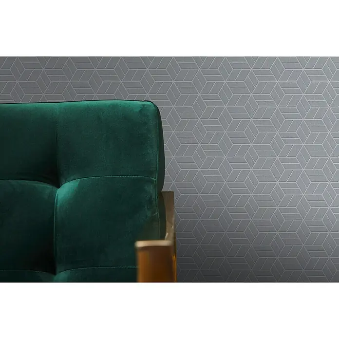 A.S. Création Metropolitan Stories Vliestapete Lizzy - Grau, 3D-Optik, 10,05 x 0,53 m - Ein grünes Sofa mit grauem, geometrischem Hintergrund, der einen modernen Touch verleiht. Stilvolle Akzente für Ihr Zuhause!