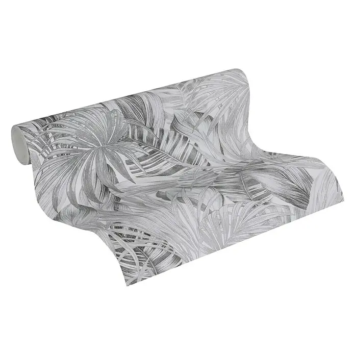 A.S. Création Greenery Vliestapete Dschungel - Schwarz/Weiß, Floral, 10,05 x 0,53 m - Eine Rolle graue Tapete mit tropischem Blattmuster. Die Tapete ist teilweise aufgerollt, um das Muster zu zeigen.