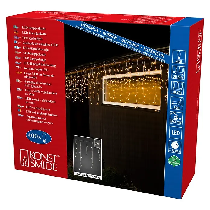 Konstsmide LED-Lichtervorhang Eisregen - Außen, 20,27 m, Warmweiß, 400 Stk., Netzbetrieben - Rote Produktverpackung für 400 warmweiße LED-Eiszapfenlichter, die eine Hausfassade beleuchten.