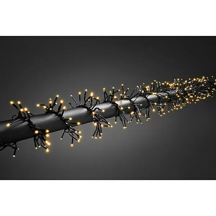 Konstsmide LED-Clusterlichterkette Micro LED Cluster - Außen, Länge: 9,3 m, 576 Stk., Netzbetrieben, Lichtfarbe: Bernstein - Warmweiße LED-Lichterkette mit schwarzen Kabeln um ein dunkles Rohr gewickelt.