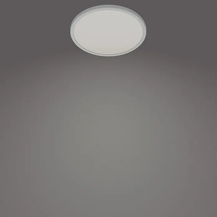 Philips Plafón LED redondo SceneSwitch - 18 W, Ø x Al: 300 mm x 2,3 cm, Blanco, Blanco neutro - Una lámpara de techo circular blanca ilumina una habitación gris con una luz suave, añadiendo un toque moderno.