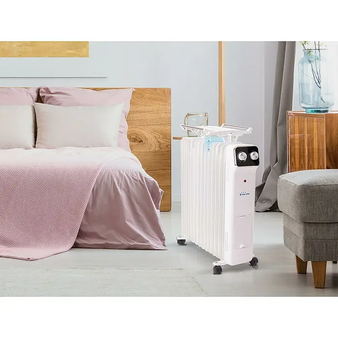 Purline Radiador de aceite HOTI OR2000 - 2.000 W, Blanco, 14,5 x 38,5 x 61,5 cm - Primer plano de un radiador de aceite blanco en el dormitorio, que ofrece calor y confort.