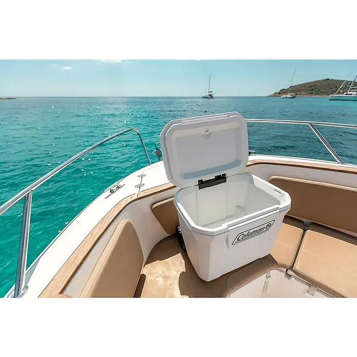 Coleman Nevera de camping Xtreme Marine - L x An x Al: 44 x 46 x 58 cm, Blanco, 47 l, Ruedas - Nevera blanca Coleman en un barco con vista al mar. Perfecto para bebidas y aperitivos en el agua. Ideal para viajes en barco.