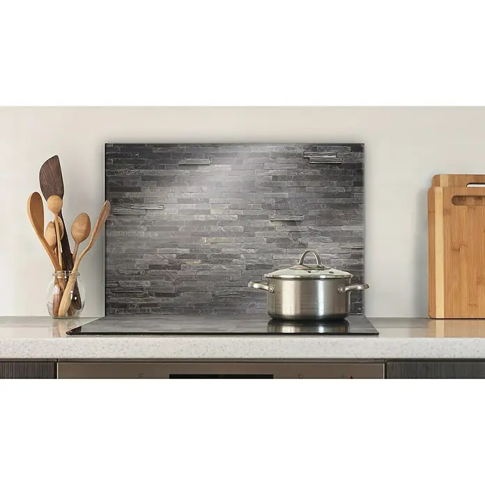 CUCINE Küchenrückwand - Stonehenge, 60 x 40 cm, Stärke: 6 mm, Einscheibensicherheitsglas (ESG) - Ein Kochtopf mit Deckel steht auf einem modernen Induktionskochfeld vor einer stilvollen Küchenrückwand.