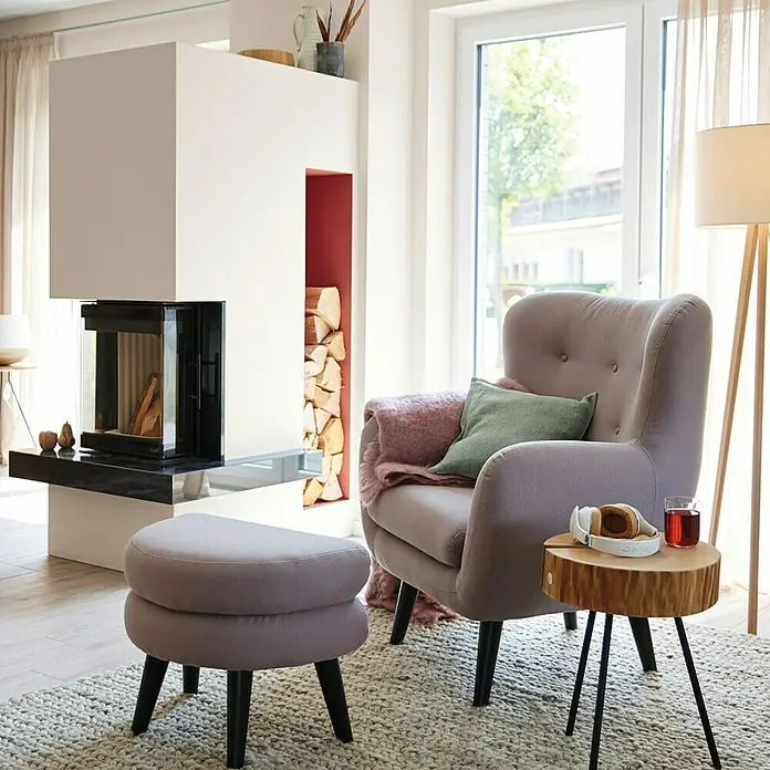 SCHÖNER WOHNEN-Farbe Wandfarbe Trendfarbe - Pearl, Matt, 2,5 l, Konservierungsmittelfrei - Wohnzimmer-Szene mit einem stilvollen Sessel, einem passenden Hocker und einem Beistelltisch auf einem strukturierten Teppich.