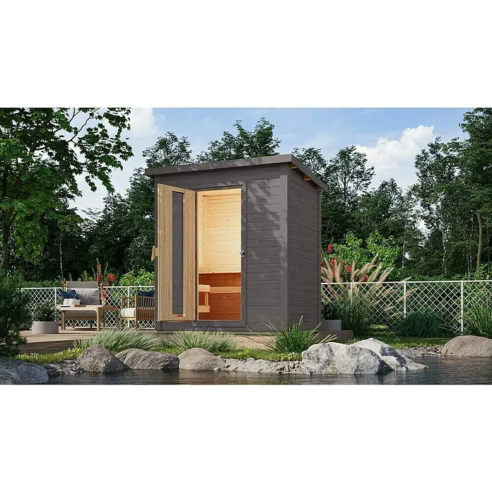 Karibu Saunahaus Hytti - 9 kW Bio-Saunaofen mit externer Steuerung, Terragrau, L x B x H: 146 x 196 x 228 cm - Außenaufnahme einer stilvollen grauen Gartensauna mit offener Tür, die einen Einblick in den hellen Holzinnenraum bietet.