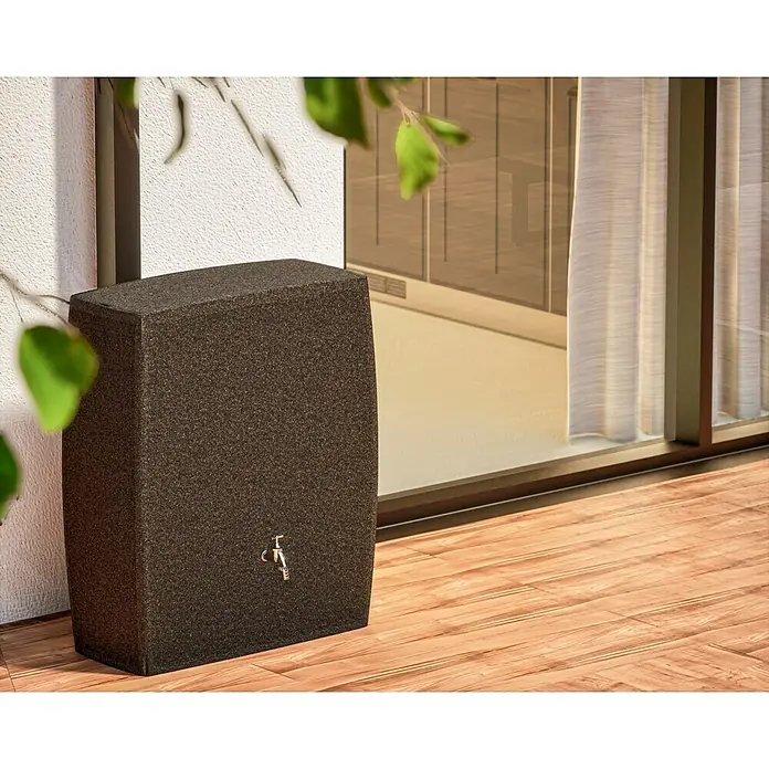 Arves Regenspeicher Boxy - 720 l, Granitkörnung, 1 Stk. - Stilvolle Regentonne in Anthrazit mit Messinghahn auf einer Holzterrasse vor einem Fenster. Perfekt für die Gartenbewässerung und Regenwassernutzung.