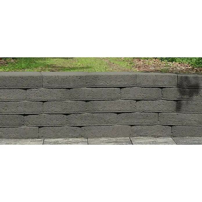 Christoph Mauerstein Antikblock - 30 x 15 x 7,5 cm, Anthrazit, Beton - Nahaufnahme einer grauen Ziegelmauer, die eine solide und robuste Bauweise mit rustikalem Charme zeigt.