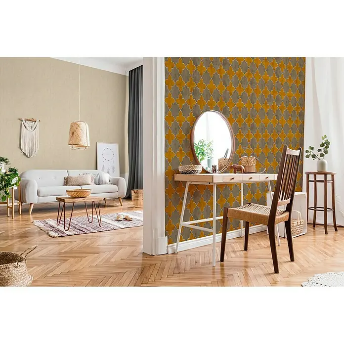 A.S. Création New Walls Vliestapete Stern Fliese - Grau/Gelb, Fliesenoptik, 10,05 x 0,53 m - Ein stilvolles Interieur mit einer gemusterten Wand, einem hellen Sofa und einem Holztisch, das eine gemütliche und einladende Atmosphäre schafft.
