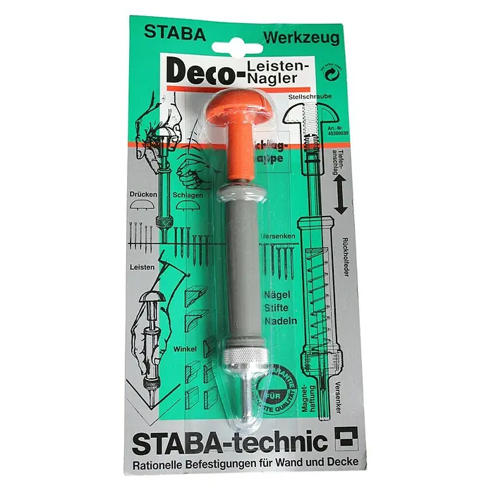 Staba Leistennagler - Geeignet für: Leisten - Eine Staba Deco-Leisten-Nagler-Verpackung mit Werkzeug zum Befestigen von Leisten an Wänden und Decken. Das Werkzeug ist orange und grau.
