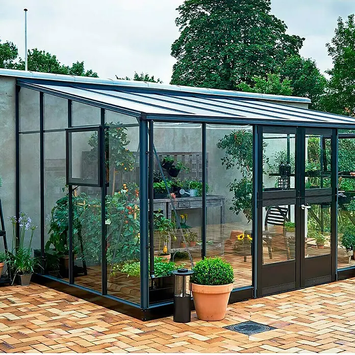 Juliana Gewächshaus Veranda - Außenmaß inkl. Dachüberstand (B x T): 293 x 439 cm, Material Seitenwand: Glas, 3 mm, Anthrazit - Gewächshaus mit Pflanzen in Töpfen und Beeten, das eine Vielzahl von Gemüse und Blumen beherbergt. Eine Oase der Ruhe und des Wachstums.