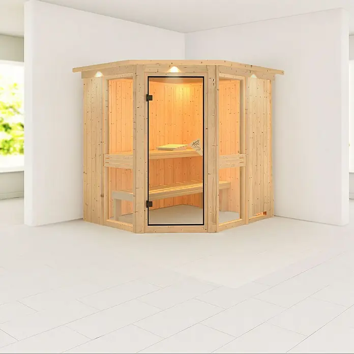 Karibu Elementsauna Amelia 1 - Ohne Ofen, Mit Dachkranz und Beleuchtung, L x B x H: 210 x 184 x 192 cm - Eine Ecksauna aus hellem Holz mit Glasfront, die ein entspannendes Saunaerlebnis in Ihrem Zuhause verspricht.