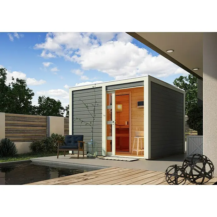 Karibu Saunahaus Cuben - 9 kW Saunaofen mit externer Steuerung, Terragrau, L x B x H: 276 x 276 x 210 cm - Eine moderne Gartensauna mit Glasfront und Holzelementen neben einem kleinen Pool unter blauem Himmel.