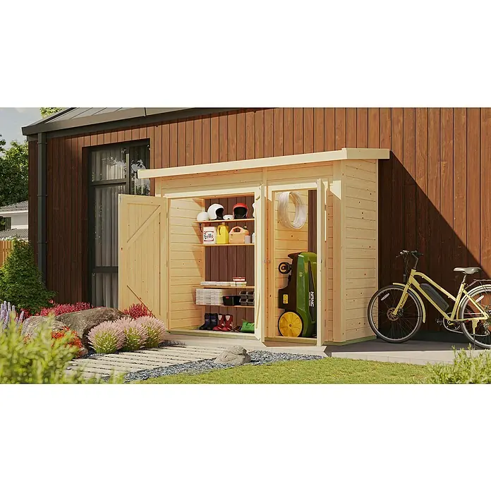 Karibu Geräteschrank - Außenbreite inkl. Dachüberstand: 291 cm, Außentiefe inkl. Dachüberstand: 110 cm, Holz, Natur - Eine offene Holzgartenhütte mit Regalen, gefüllt mit Werkzeugen und Zubehör, neben einem gelben Fahrrad an einer hölzernen Wand.
