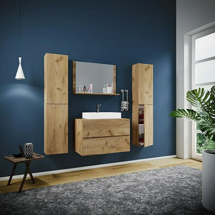 VCM Lendas Badmöbel-Set127 cm, Honig-Eiche - Badezimmer-Interieur mit Waschtisch, Spiegel und Schränken in Holzoptik vor einer blauen Wand. Moderne Badgestaltung.