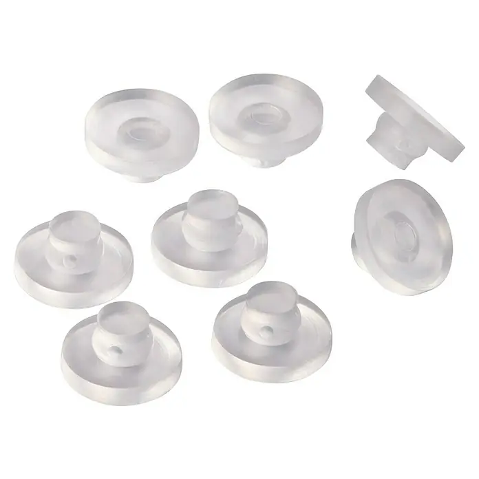 Fix-o-moll Gummiauflage - Durchmesser: 16 mm, 8 Stk. - Nahaufnahme von Ohrringstoppern aus durchsichtigem Silikon mit flacher, runder Form und kleinem Stift in der Mitte, ideal für Ohrringe.