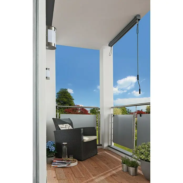 Sunfun Balkonverschattung - Grau, Breite: 1,4 m, Ausfall: 2,5 m - Balkon mit stilvollem Rattansessel, Holzfußboden und Außenleuchten. Die Markise bietet zusätzlichen Schatten und Privatsphäre.