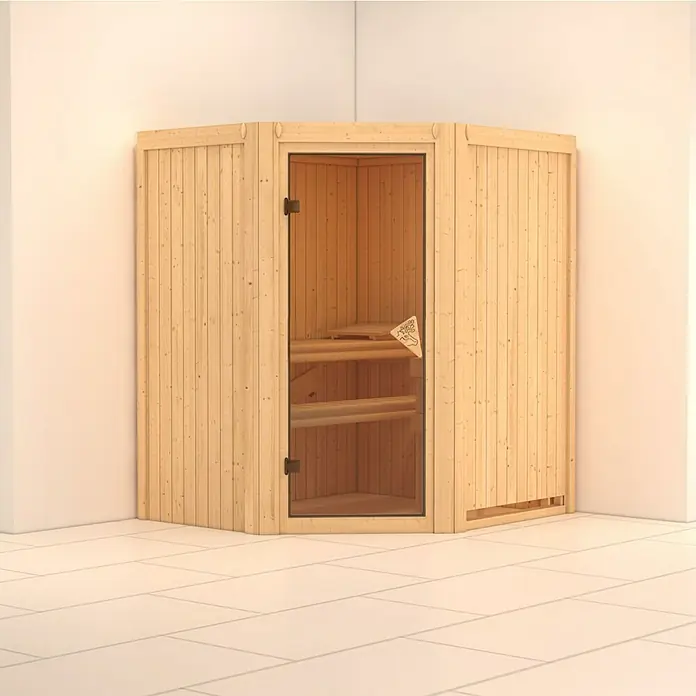 Karibu Elementsauna Tonja - Ohne Ofen, Ohne Dachkranz, L x B x H: 170 x 151 x 192 cm - Freistehende Sauna aus hellem Holz mit Glastür in einer Ecke des Raumes.