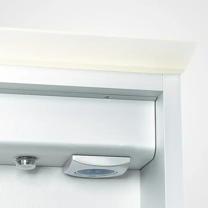 DSK LED-Spiegelschrank Aluminio Light - B x H: 60 x 70 cm, Silber - Detailaufnahme eines silbernen automatischen Türöffners mit Sensoren, montiert an einer weißen Tür.