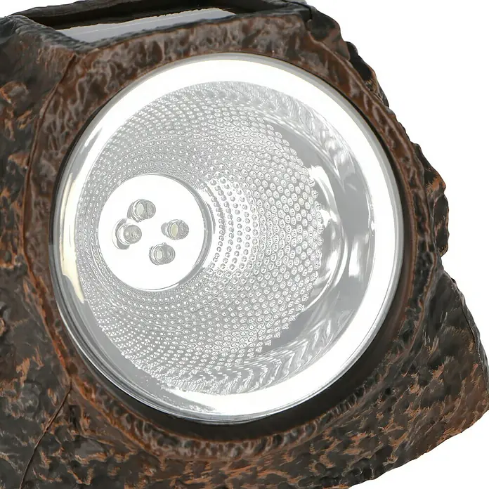BAUHAUS Solarstein Rock - LED - Nahaufnahme einer Solarleuchte in Steinoptik mit LED-Lichtern, die ein warmes und einladendes Licht ausstrahlen.