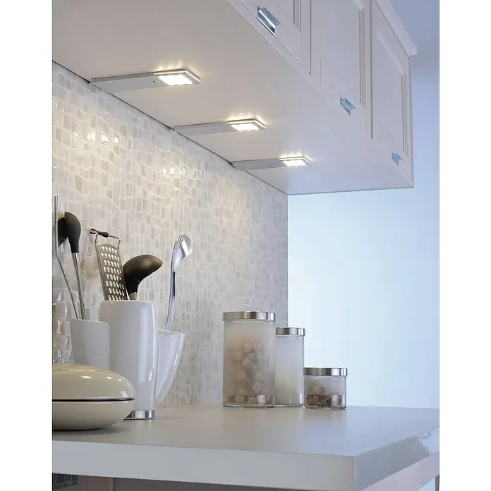Paul Neuhaus LED-Unterbauleuchten-Set - 6 W, Länge: 190 mm, Warmweiß, Matt, 3 Stk. - Küchenarbeitsplatte mit drei Glasbehältern und Küchenutensilien unter LED-Unterbauleuchten für optimale Beleuchtung.