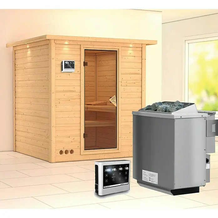 Karibu Elementsauna Mojave - Mit 9 kW Bio-Ofen mit externer Steuerung, Mit Dachkranz und Beleuchtung, Materialspezifizierung Tür: Ganzglas Bronze, L x B x H: 224 x 210 x 192 cm - Das Bild zeigt eine Sauna mit Holzverkleidung, einem Ofen mit Steinen und einer Steuerungseinheit für ein entspannendes Saunaerlebnis.