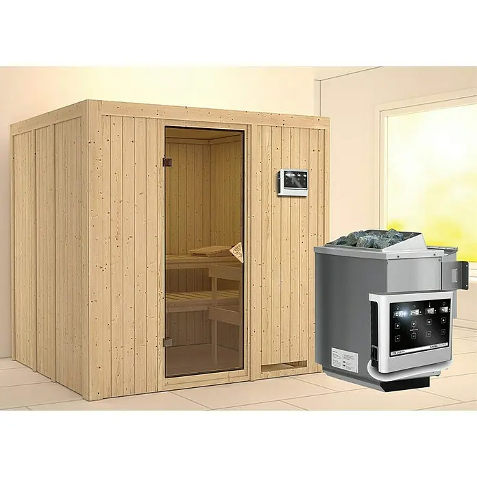 Karibu Elementsauna Sodin - Mit 9 kW Bio-Ofen mit externer Steuerung, Ohne Dachkranz, L x B x H: 196 x 170 x 192 cm - Das Bild zeigt eine Sauna mit einem Saunaofen. Die Sauna ist aus hellem Holz und hat eine Glastür. Der Ofen ist silbern und hat Steine.