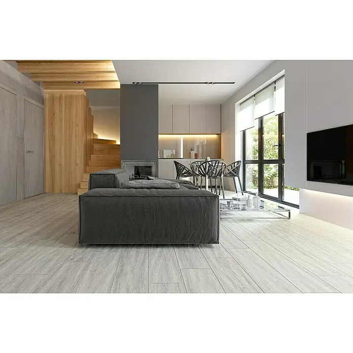 Feinsteinzeugfliese Natura - 22,5 x 90,2 cm, Tortora, Matt - Ein modern gestaltetes Wohnzimmer mit einem grauen Sofa und hellen Holzböden, das ein helles und stilvolles Ambiente ausstrahlt.