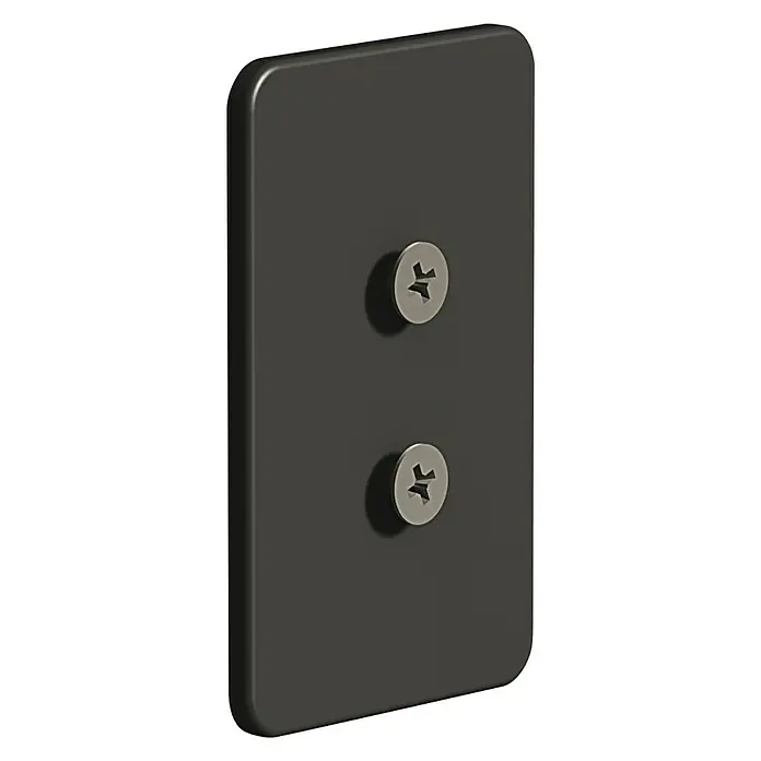 Creabath Placa de soporte adhesiva Soul Black - L x An: 0,4 x 4,5 cm - Primer plano de una placa de pared rectangular negra con dos tornillos empotrados, utilizada para fijar el producto a una superficie de pared.