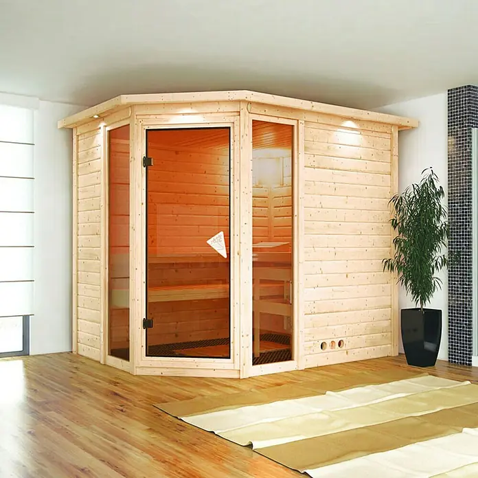 Karibu Massivholzsauna Sinai 3 - Mit 9 kW Bio-Ofen mit externer Steuerung, Mit Dachkranz und Beleuchtung, L x B x H: 264 x 198 x 200 cm - Das Bild zeigt eine Ecksauna mit Glastür und Holzverkleidung in einem Badezimmer. Neben der Sauna steht eine Zimmerpflanze.