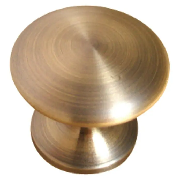 Nesu Pomo para muebles 25315 - Ø x Al: 30 x 27 mm, Acero, Dorado - Primer plano de un tirador de mueble circular, color bronce, con una superficie lisa y redondeada y un aspecto decorativo.