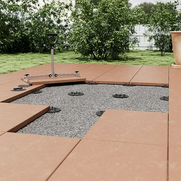 Langfit Kieslager - 10 Stk., Kunststoff, Ganze Scheibe - Bild einer Terrassenkonstruktion mit Terrassenplatten und Unterkonstruktionselementen im Garten, die eine robuste und ebene Fläche schaffen.