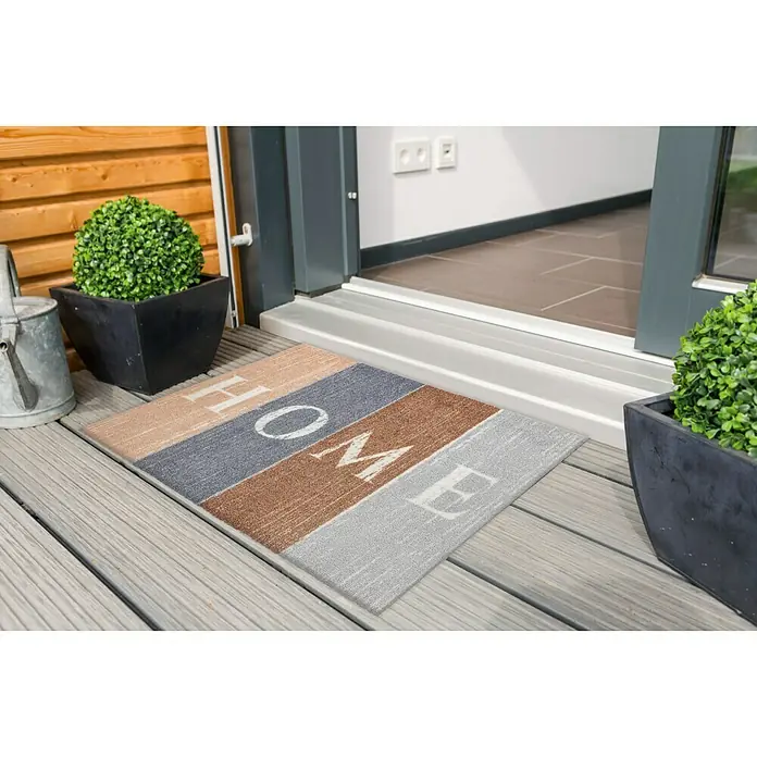 Astra Casadoor Fußmatte Home - Bunt, 50 x 70 cm, 100 % Polyamid - Eine bunte Fußmatte mit der Aufschrift "Home" vor einer Haustür, die einladend wirkt und den Eingangsbereich verschönert.