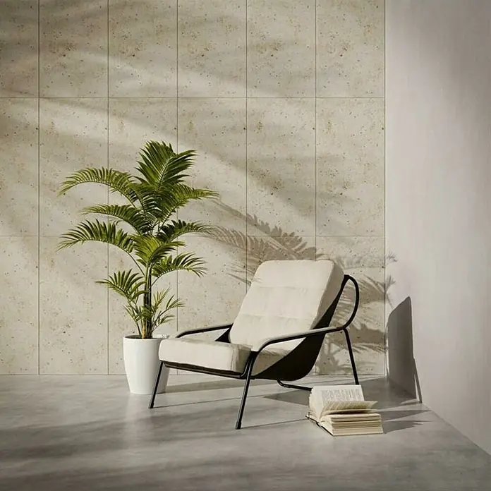 Nmc Decoflair Wandpaneel - Stone, Rosa, 100 x 50 cm, Kunststoff - Ein bequemer Sessel mit weißem Kissen, umgeben von einer Pflanze und einem Buch, in einem stilvollen und entspannenden Raum.