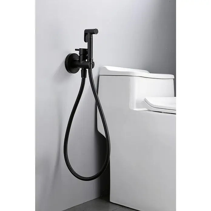 Camargue Natur Ducha higiénica inodoro - Negro - Un bidé negro mate con manguera montado en una pared junto a un inodoro blanco. Accesorio de baño moderno con un diseño elegante.