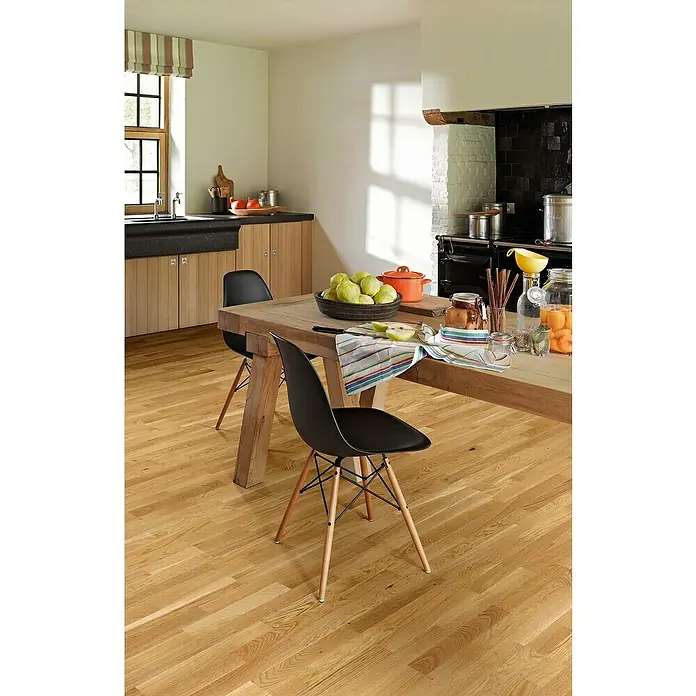 Parador Parkettmuster Classic 3060 Living Eiche - 200 x 185 x 13 mm, Schiffsboden - Esszimmer mit Holztisch und schwarzen Stühlen, dekoriert mit Obst und Einmachgläsern, helles Holzparkett sorgt für Wärme.