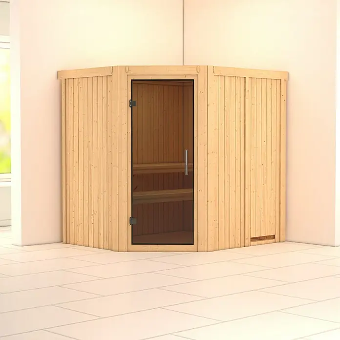 Karibu Elementsauna Siirin - Ohne Ofen, Ohne Dachkranz, Materialspezifizierung Tür: Ganzglas Graphit, L x B x H: 196 x 170 x 192 cm - Eine Ecksauna mit Glastür und Holzverkleidung steht in einem hellen Raum auf Fliesenboden. Die Sauna bietet ein entspannendes Wellness-Erlebnis.