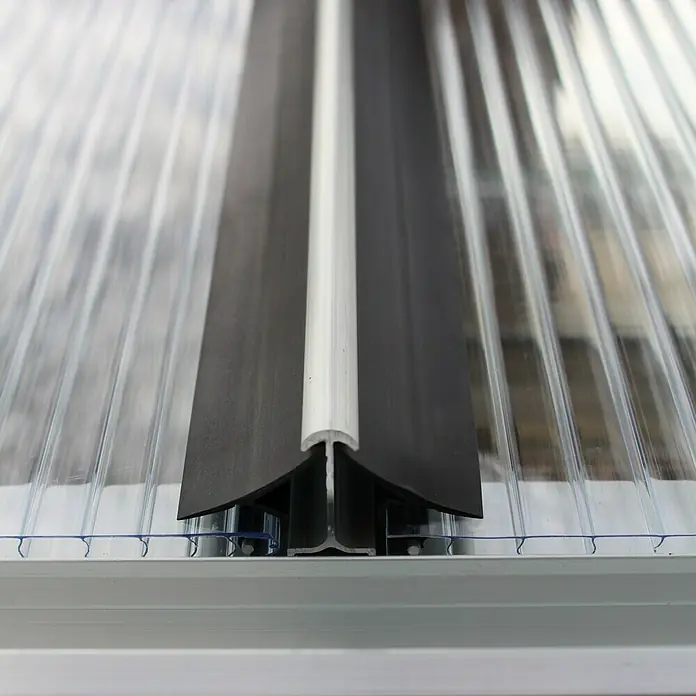 Vitavia Gewächshaus-Windsicherung - Passend für: Gewächshäuser mit 4 mm Hohlkammerplatten, Gewächshausgrößen 2,5/3/3,8/4,4 m² - Polycarbonatplatten mit Profilen: Detaillierte Ansicht der Installation von transparenten Polycarbonatplatten mit schwarzen und weißen Verbindungsprofilen.