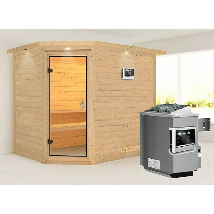Karibu Massivholzsauna Tanami - Mit 9 kW Ofen mit externer Steuerung, Mit Dachkranz und Beleuchtung, L x B x H: 259 x 210 x 192 cm - Moderne Sauna mit Holzwänden, Glastür und einem grauen Saunaofen mit Steinen für ein entspannendes Saunaerlebnis.