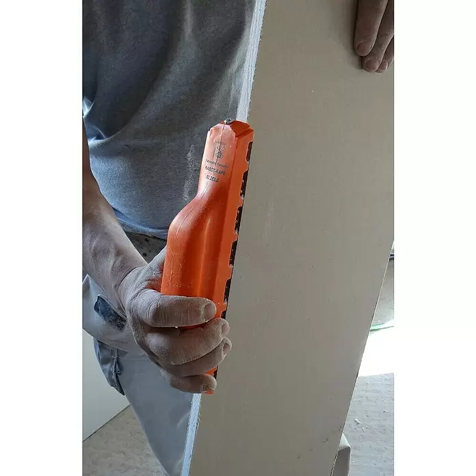 Mondelin Kantenhobel - Länge: 255 mm - Person glättet Gipskartonkante mit orangefarbener Gipskartonraspel.