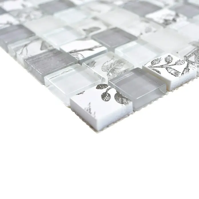 Mosaikfliese Quadrat Crystal XCM JT12 - 29,8 x 29,8 cm, Grau, Glänzend - Nahaufnahme eines Mosaikfliesenmusters in Weiß, Grau und mit zarten botanischen Motiven. Die Fliesen sind quadratisch und scheinen aus Glas zu sein.