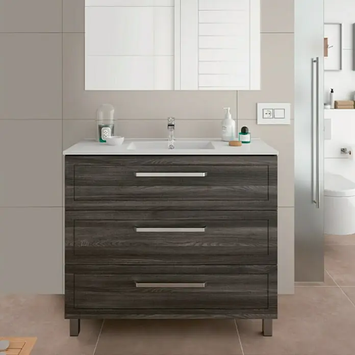 Lavabo Cristal - 101 x 46 cm, Orificios para grifo: Medio, Sin desbordamiento, Blanco oxido - Mueble de baño con tres cajones en aspecto de madera oscura y lavabo sobre encimera blanco.