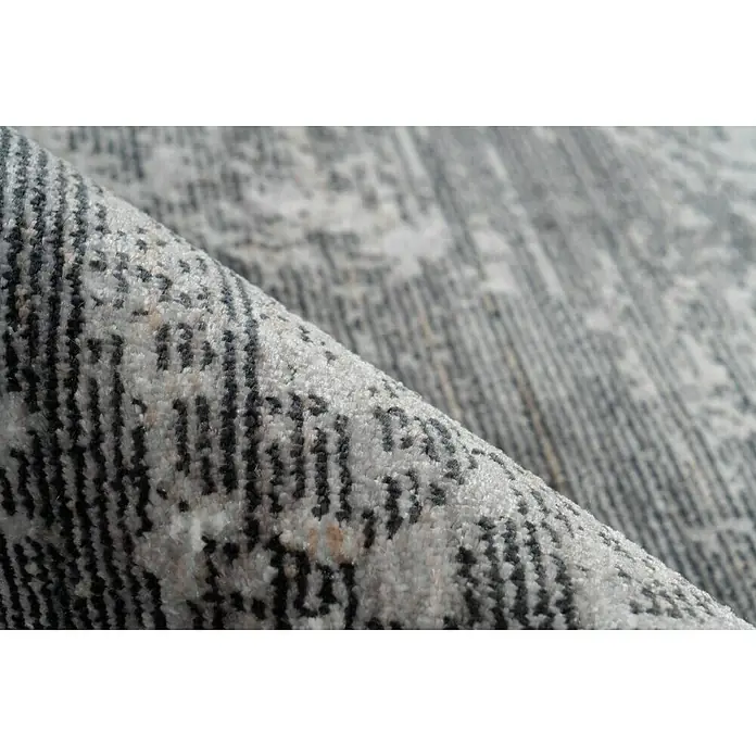 Kayoom Kurzflorteppich Baroque I - Anthrazit, 290 x 200 cm, 100 % Polyester - Nahaufnahme eines grauen Teppichs mit abstraktem Muster, der eine weiche Textur und hochwertige Verarbeitung zeigt.