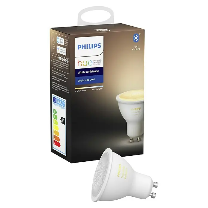 Philips Hue Bombilla LED inteligente - GU10, Intensidad regulable, Blanco cálido, 350 lm, 5,7 W - Primer plano de la bombilla Philips Hue White Ambiance GU10 y su embalaje. Iluminación inteligente para un hogar acogedor.