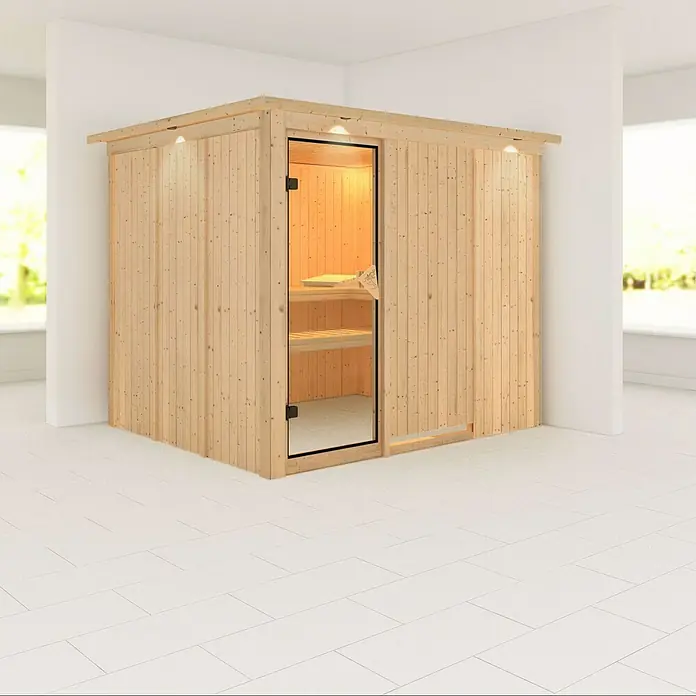 Karibu Elementsauna Gobin - Ohne Ofen, Mit Dachkranz und Beleuchtung, L x B x H: 245 x 210 x 192 cm - Holzsauna mit Glastür und integrierter Beleuchtung in einem hellen Raum mit Fliesenboden.